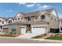 Beautiful two-story home featuring a manicured lawn, attached two car garage, and neutral colored siding at 11142 Bright Sky St, Littleton, CO 80125