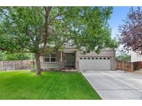 Charming brick home with a well-manicured lawn, covered porch, and a spacious two-car garage at 7171 Canyon Way, Frederick, CO 80504