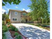 Charming two-story home with stone accents, well-kept landscaping, and a secure fenced yard at 2525 S Pennsylvania St, Denver, CO 80210