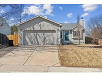 Charming single-story home with neutral siding, two-car garage, and well-maintained lawn at 19739 E Wagontrail Dr, Centennial, CO 80015