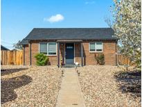 Charming brick home with a well-maintained front yard and inviting entrance at 3011 Oneida St, Denver, CO 80207