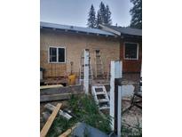 Exterior view of a home under construction with ladders and building materials around the property at 4568 Apex Valley Rd, Golden, CO 80403