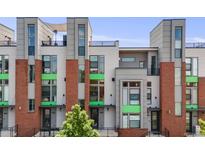 Contemporary townhouse featuring a red brick facade, sleek gray accents, and a rooftop terrace at 3008 Blake St, Denver, CO 80205