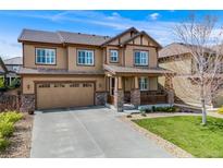 Charming two-story home with a covered front porch and well-manicured lawn at 12678 Fisher Ln, Englewood, CO 80112
