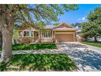 Charming single-Gathering home with stone accents, a two-car garage, and a well-manicured front lawn at 12663 S Silver Creek Ct, Parker, CO 80134