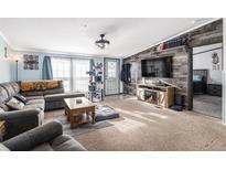 Spacious living room with sectional sofa and fireplace at 16503 Barley Ave, Fort Lupton, CO 80621