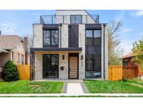 Modern home featuring a white brick facade, black trim, minimalist design, and well-manicured front lawn at 357 S Franklin St, Denver, CO 80209