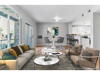 Inviting living room featuring an open concept design with modern decor and lots of natural light at 2575 S Syracuse Way # 101, Denver, CO 80231