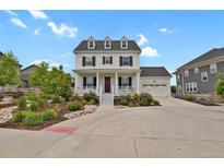 Charming two-story home with a welcoming front porch and well-manicured landscaping at 9353 Middle Fork St, Littleton, CO 80125