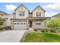 Charming two-story home with a front porch, attached garage, and well-manicured lawn at 5226 Inland Ave, Firestone, CO 80504