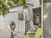 Inviting front entrance featuring a decorative wreath and a vibrant yellow adirondack chair at 11275 Holly St, Thornton, CO 80233