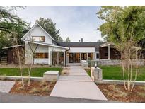 Stunning modern home with a walkway leading to the front door and professionally landscaped yard at 13905 Berry Rd, Golden, CO 80401