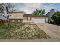 Inviting two-story home featuring a manicured front yard and attached two-car garage at 19053 E 22Nd Dr, Aurora, CO 80011