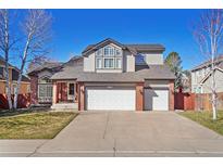 Charming two-story home features a three car garage and manicured front yard at 9603 Las Colinas Dr, Lone Tree, CO 80124