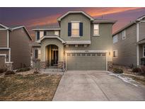 Inviting two-story home featuring a two car garage, an arched entryway, and tasteful landscaping at 1432 Red Mica Way, Monument, CO 80132