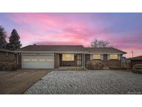 Charming brick ranch-style home featuring an attached garage and a well-maintained front yard at 581 W 87Th Pl, Thornton, CO 80260
