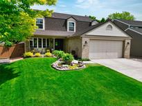 Charming home featuring a lush front lawn, beautiful landscaping, and a cozy front porch at 2011 Sundrop Trl, Highlands Ranch, CO 80126