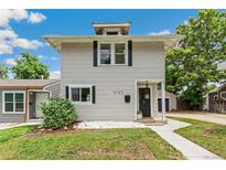 Charming two-story home with a well-manicured lawn and classic architectural details at 4142 Chase St, Denver, CO 80212