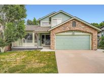 Charming two-story home with a stone-accented garage, porch, and well-maintained lawn at 5362 S Danube Ct, Centennial, CO 80015