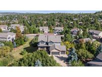 Beautiful two-story home with stone accents nestled within a vibrant community surrounded by lush trees at 1519 Stonehill Ct, Castle Rock, CO 80104