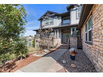 Charming two-story home with stone accents, manicured landscaping, and inviting front porch at 1519 Stonehill Ct, Castle Rock, CO 80104
