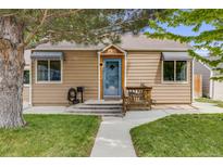 Charming home featuring a well-kept lawn, quaint porch, and welcoming blue front door at 430 at 430 Osceola St, Denver, CO 80204