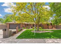 Charming brick home with mature tree, green lawn, and inviting curb appeal at 12256 W 34Th Pl, Wheat Ridge, CO 80033