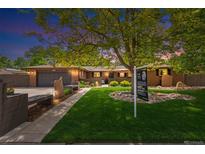 Charming brick home with lush lawn, mature trees, and for sale sign at 12256 W 34Th Pl, Wheat Ridge, CO 80033