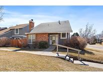 Charming single-Gathering home featuring a brick chimney and well-maintained landscaping in a desirable location at 8699 Garrison Ct, Arvada, CO 80005