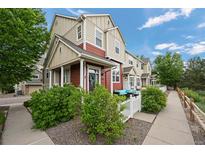 Charming townhome with a well-maintained yard, white picket fence, and inviting curb appeal at 1464 Nemrick Pl, Castle Rock, CO 80109