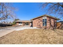 Charming brick home featuring a well-manicured front yard and inviting entrance at 8895 E Radcliff E Ave, Denver, CO 80237