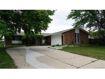 Charming brick home featuring a well-manicured lawn and a spacious driveway at 8895 E Radcliff E Ave, Denver, CO 80237