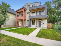 Modern two-story home featuring a well-manicured lawn and a combination of siding and brick exterior finishes at 4535 Stuart St, Denver, CO 80212