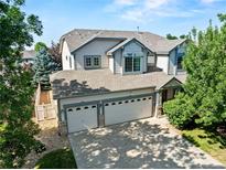 Inviting two-story home features a three-car garage, lush landscaping, and a charming exterior at 6808 Silverleaf Ave, Firestone, CO 80504
