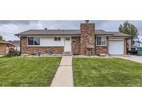 Charming single-Gathering home with brick exterior, a well-manicured lawn, and an attached one-car garage at 2560 Westchester Dr, Denver, CO 80221