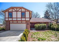 Charming two-story Tudor-style home with a brick facade and a well-manicured front yard in a suburban neighborhood at 5138 S Sedalia Ct, Centennial, CO 80015