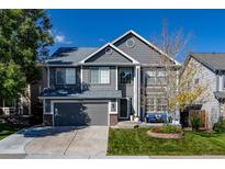 Two-story house with gray siding, landscaped yard, and a two-car garage at 5630 Spruce Ave, Castle Rock, CO 80104