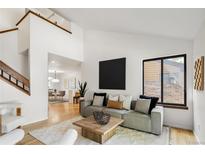 The living room is well-lit, with an open floor plan and hardwood floors at 9400 E Iliff Ave # 292, Denver, CO 80231