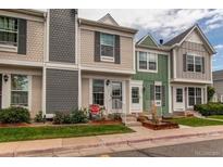 Charming townhome with a well-maintained front yard and inviting entrance at 19807 Victorian Way, Parker, CO 80138