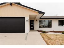 Charming home featuring a modern design with a black garage door and beautifully manicured front yard at 6285 S Oneida Way, Centennial, CO 80111