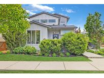 Charming two-story home featuring a landscaped front yard, inviting entrance, and attractive curb appeal at 1882 W 67Th Ave, Denver, CO 80221