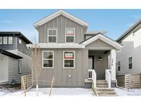 Charming two-story home with gray siding, white trim, and inviting front porch at 7376 Watercress Dr, Littleton, CO 80125