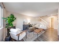 Inviting living room featuring a fireplace, stylish furniture, and staircase at 18314 W 58Th Pl # 54, Golden, CO 80403