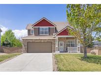 Charming two-story home featuring a brick and siding exterior, attached garage, and well-manicured front lawn at 217 Peabody St, Castle Rock, CO 80104