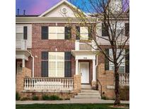 Charming brick home with a welcoming front porch and black shutters at 3818 S Dallas St, Aurora, CO 80014