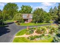 Beautifully landscaped home with a circular driveway and mature trees at 4181 S Colorado Blvd, Cherry Hills Village, CO 80113