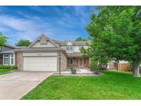 Charming two-story home with brick accents, a well-manicured lawn, and a two-car garage at 19149 E Ida Dr, Aurora, CO 80015