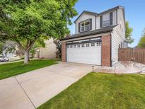 Charming two-story home with a spacious two-car garage and well-manicured lawn at 9867 Mulberry Way, Highlands Ranch, CO 80129
