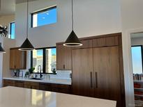 Modern kitchen with wood cabinets, quartz countertops, and high-end appliances at 39426 Stockton Cir, Elizabeth, CO 80107