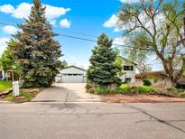 Charming home with a detached garage, long driveway, and mature trees at 431 N Harlan St, Lakewood, CO 80226